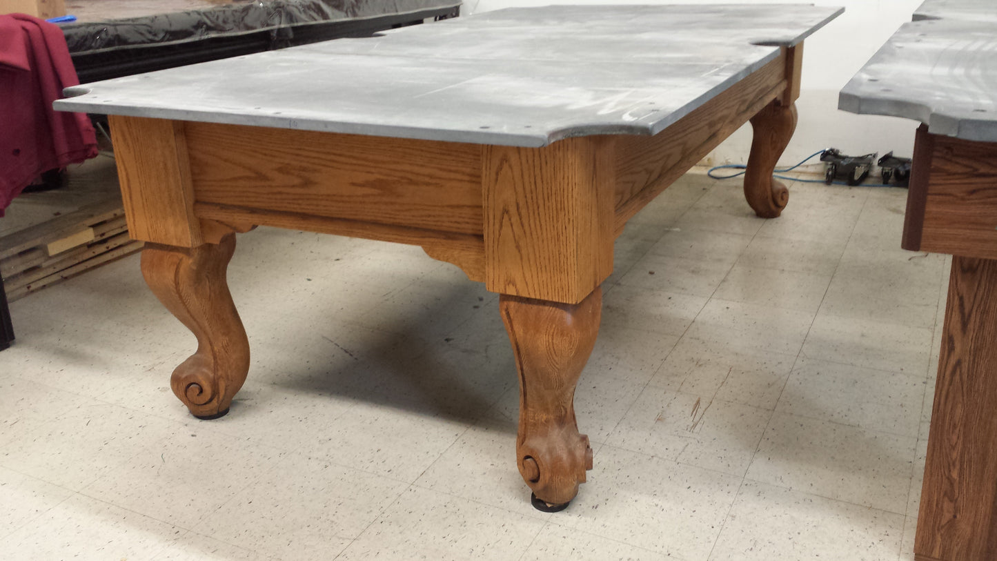 Pool table without felt covering, exposing bare slate surface and base