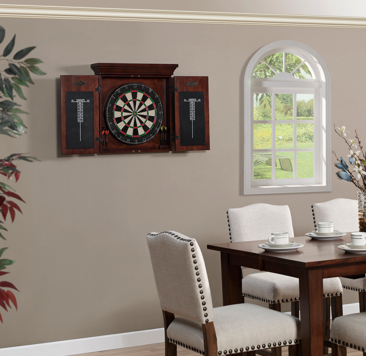 Dartboard cabinet mounted on wall above dining table in home interior setting