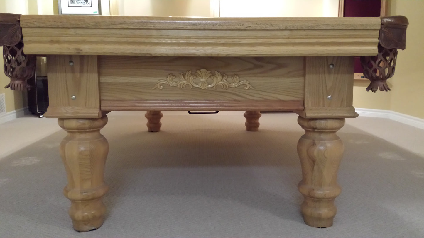 Rear perspective of pool table displaying ornate wooden frame and legs