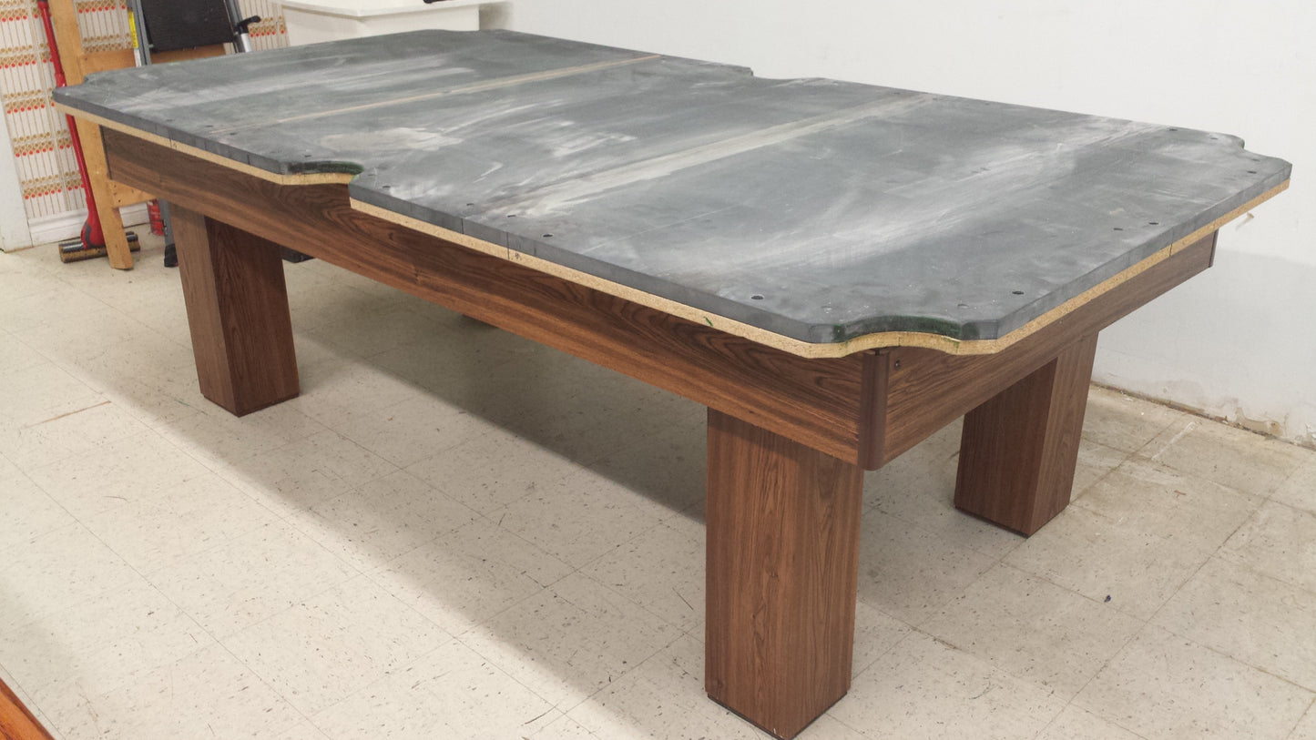 Slate playing surface installed on wooden pool table frame
