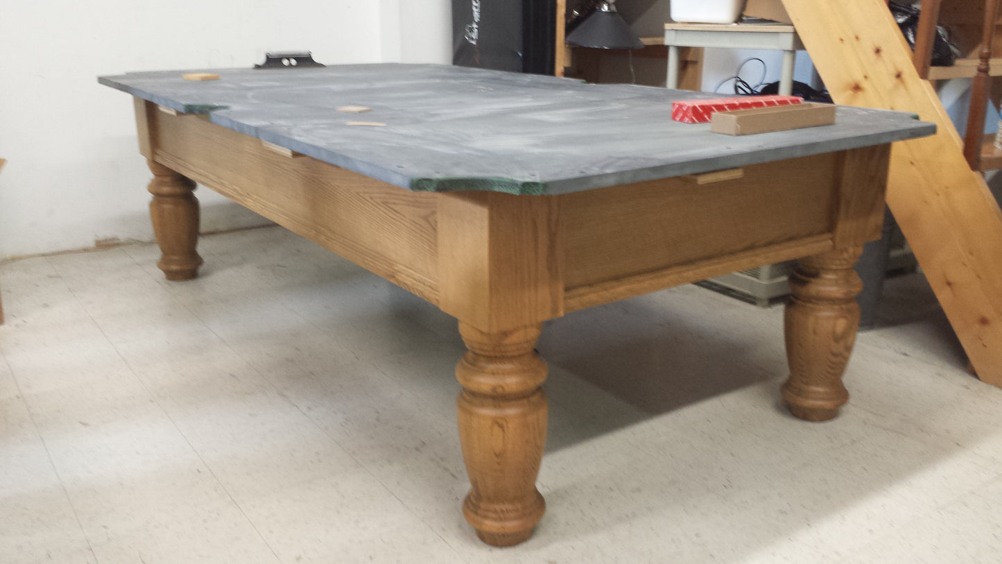 Slate surface of preowned pool table without felt covering