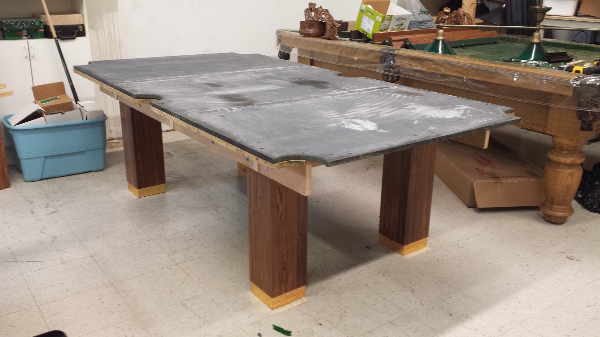 Slate playing surface covered with protective material