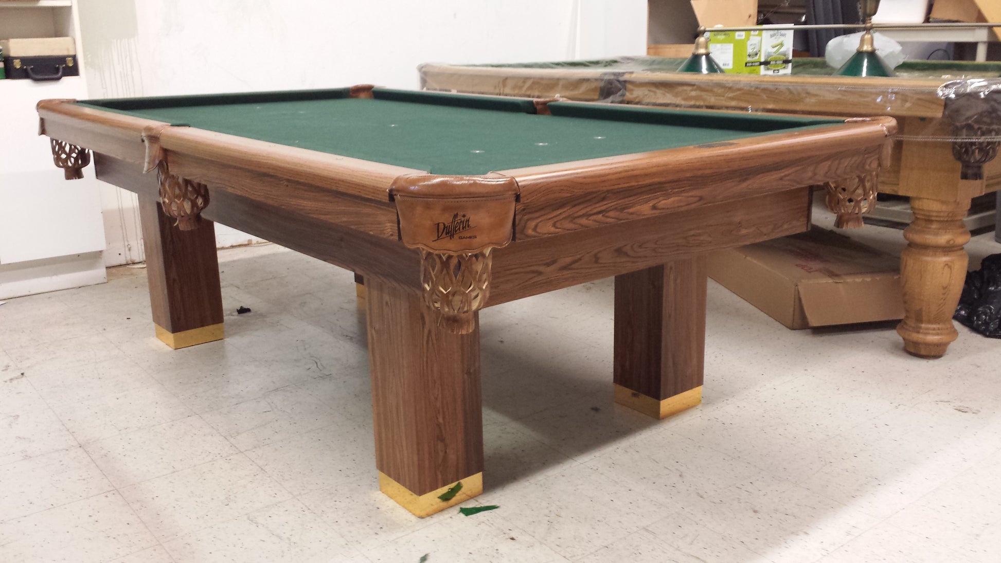 Fully assembled 8-foot billiard table with decorative leg carvings