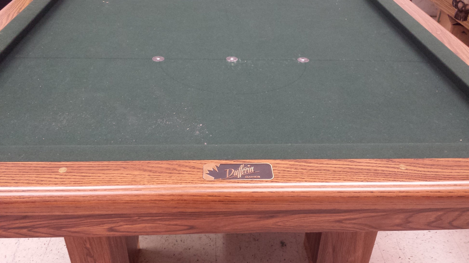 Close-up of Dufferin nameplate on wooden rail edge