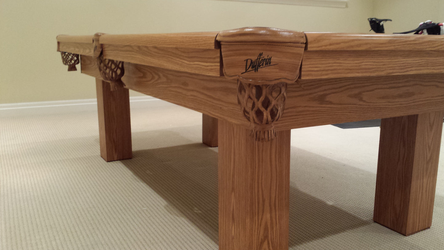 Angled view of table frame showing carved corner details and rail design