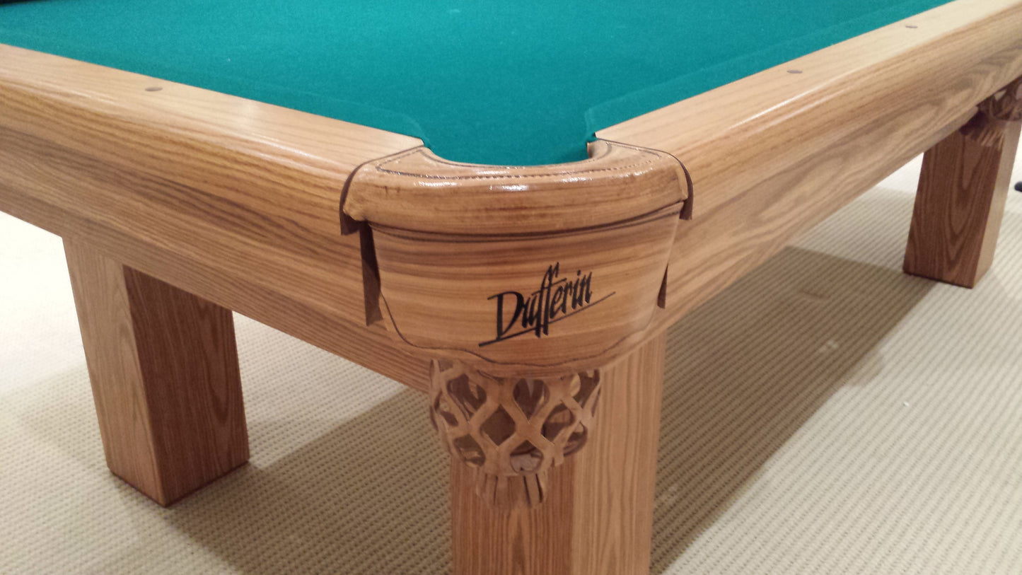 Corner pocket detail with decorative wood carving and brand nameplate