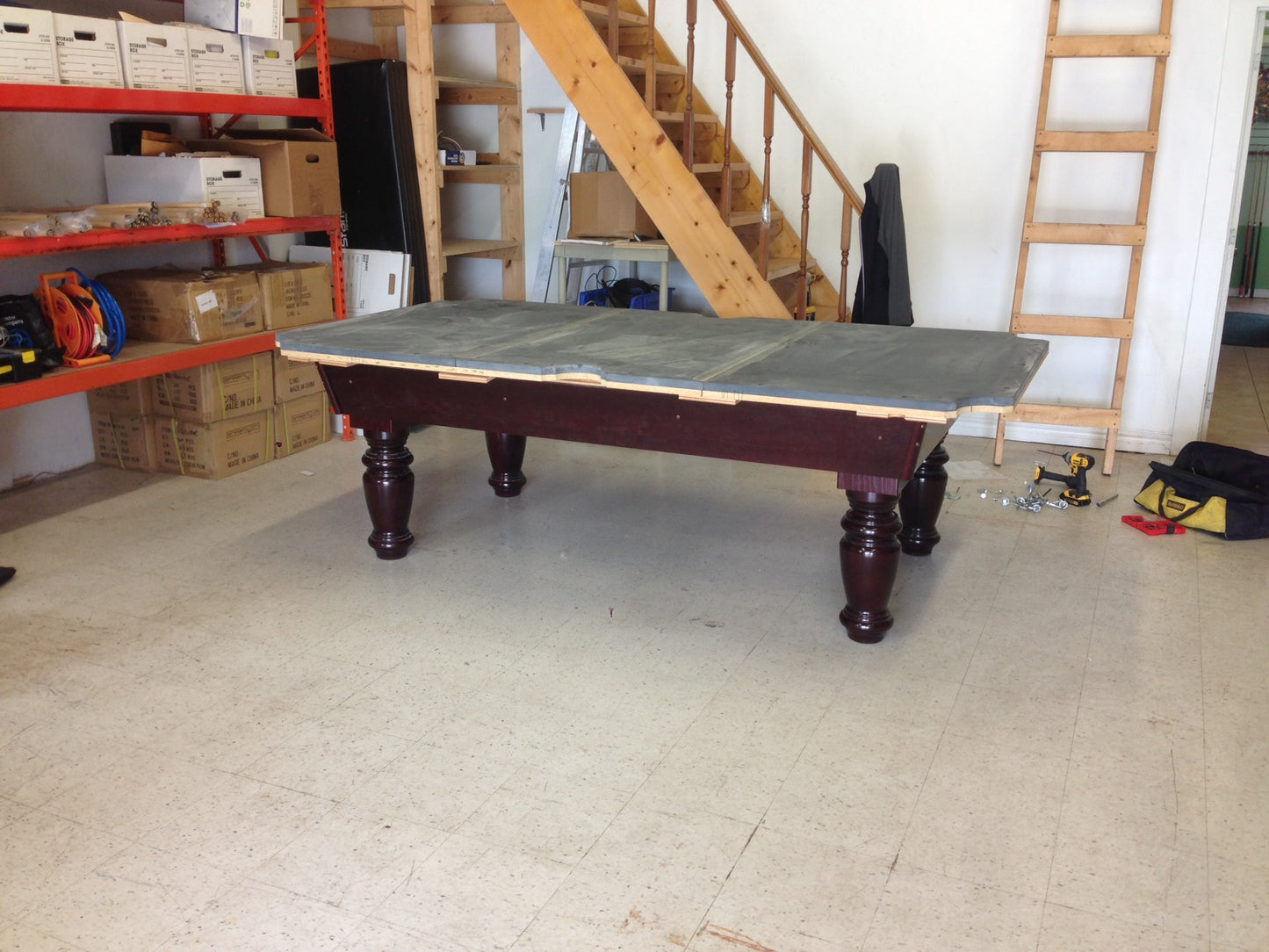 Gray slate playing surface fitted to burgundy frame and leg assembly