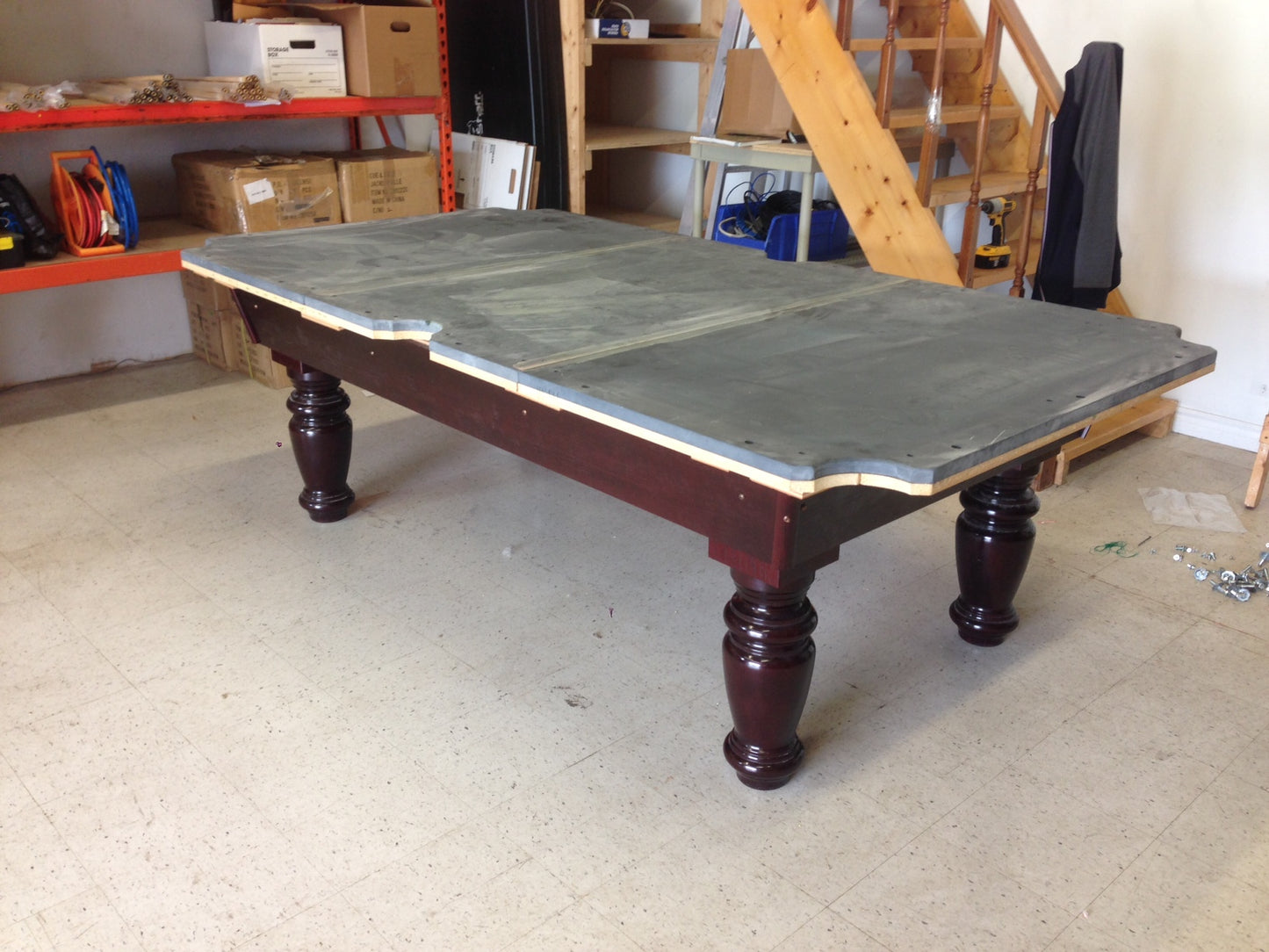 Angled view of completed table showing slate bed and dark wood frame