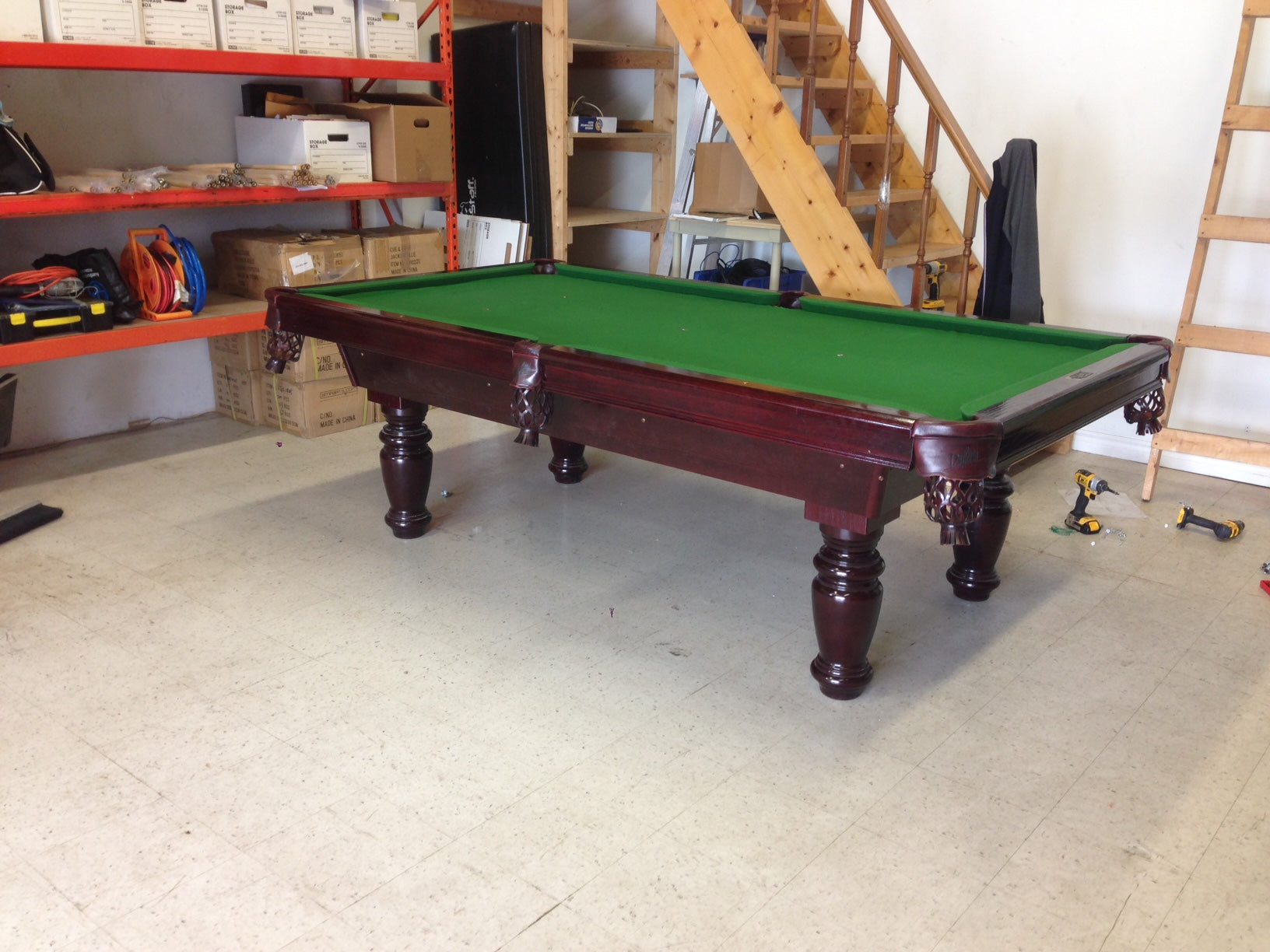 Green felt cloth installed on slate with turned legs and dark wood rails