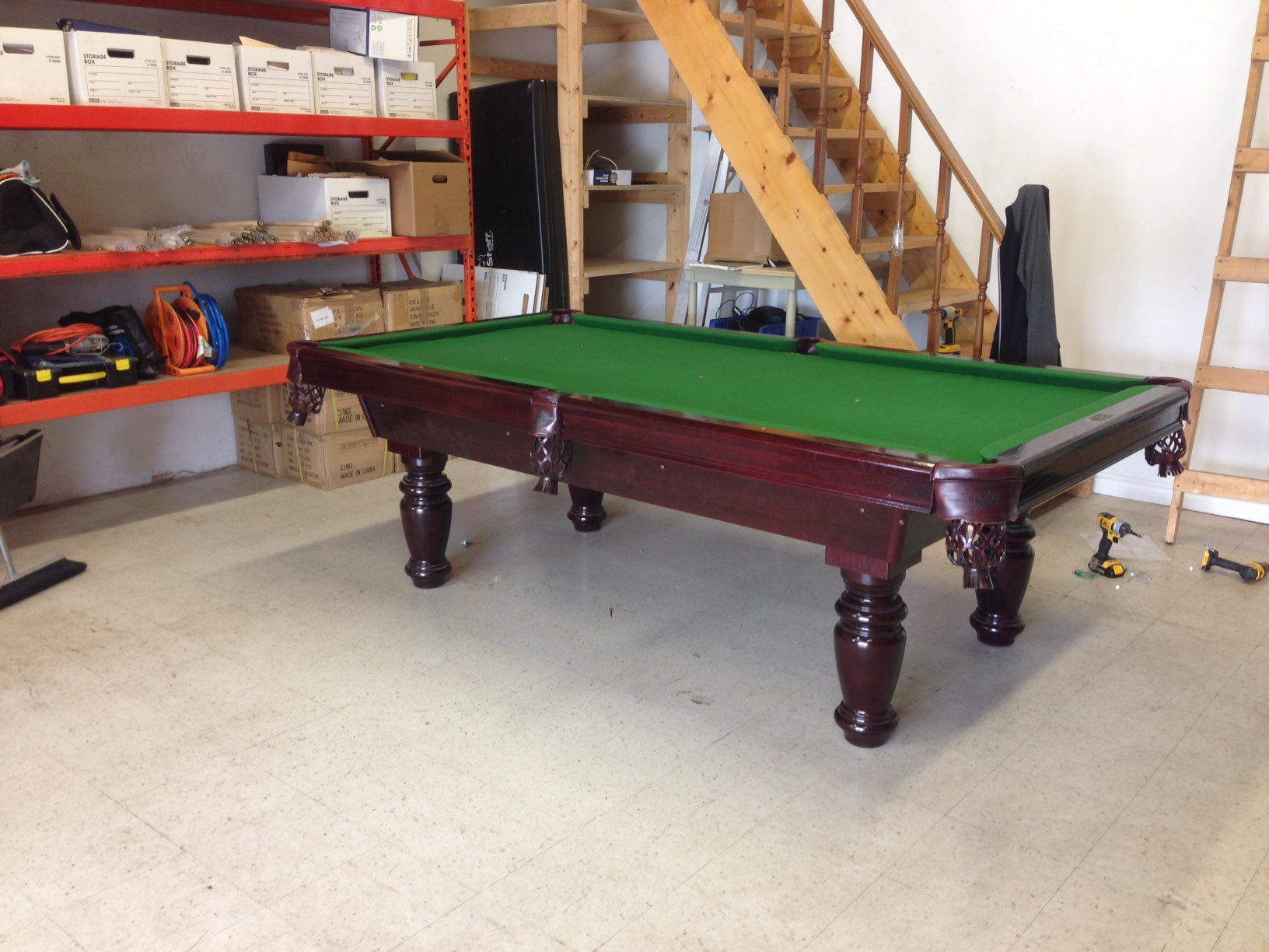 Green playing surface and cushioned rails on fully assembled table