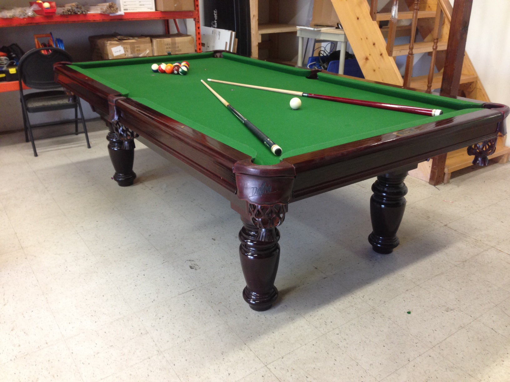 Overhead view with billiard balls and cues positioned on green felt