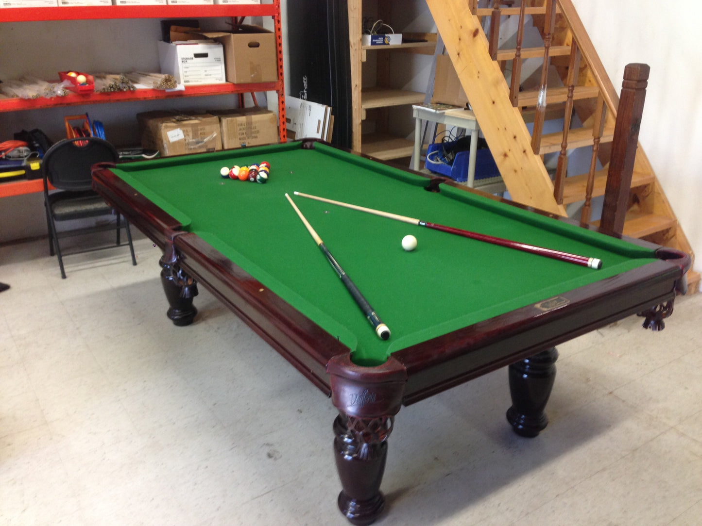 Angled perspective showing balls, chalk, and cue stick on green cloth