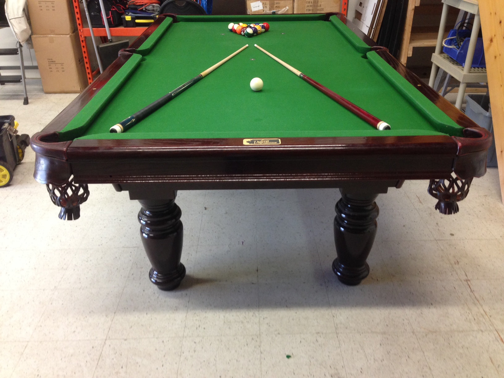Head-on view of table with ball setup and cues ready for play