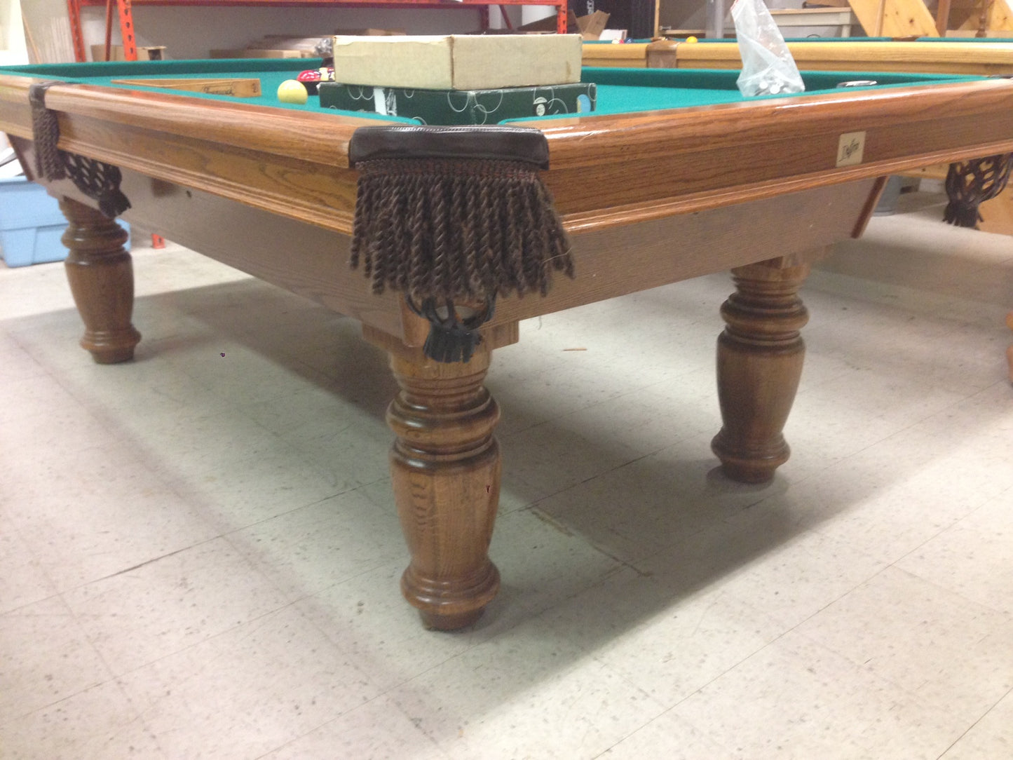 Close-up of wooden rail and turned legs with black fringe pocket