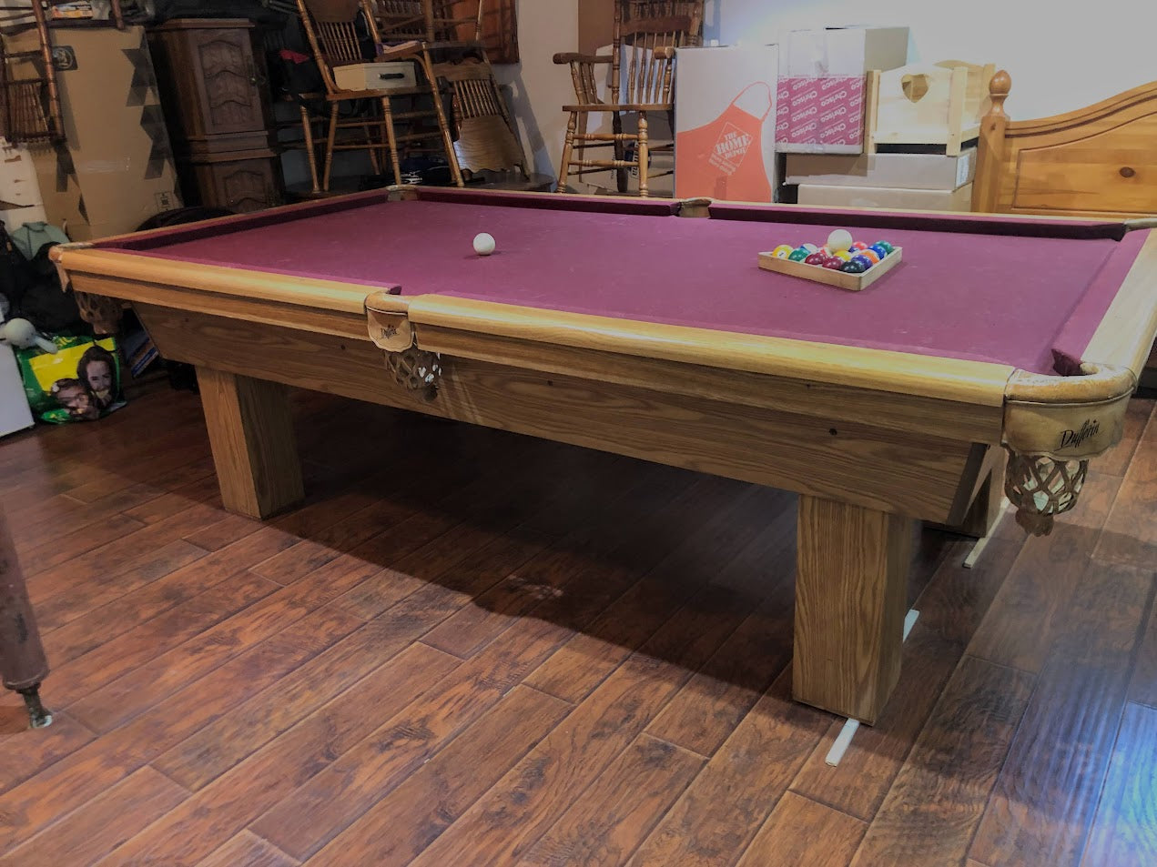 Angled side view of billiard table with burgundy playing surface
