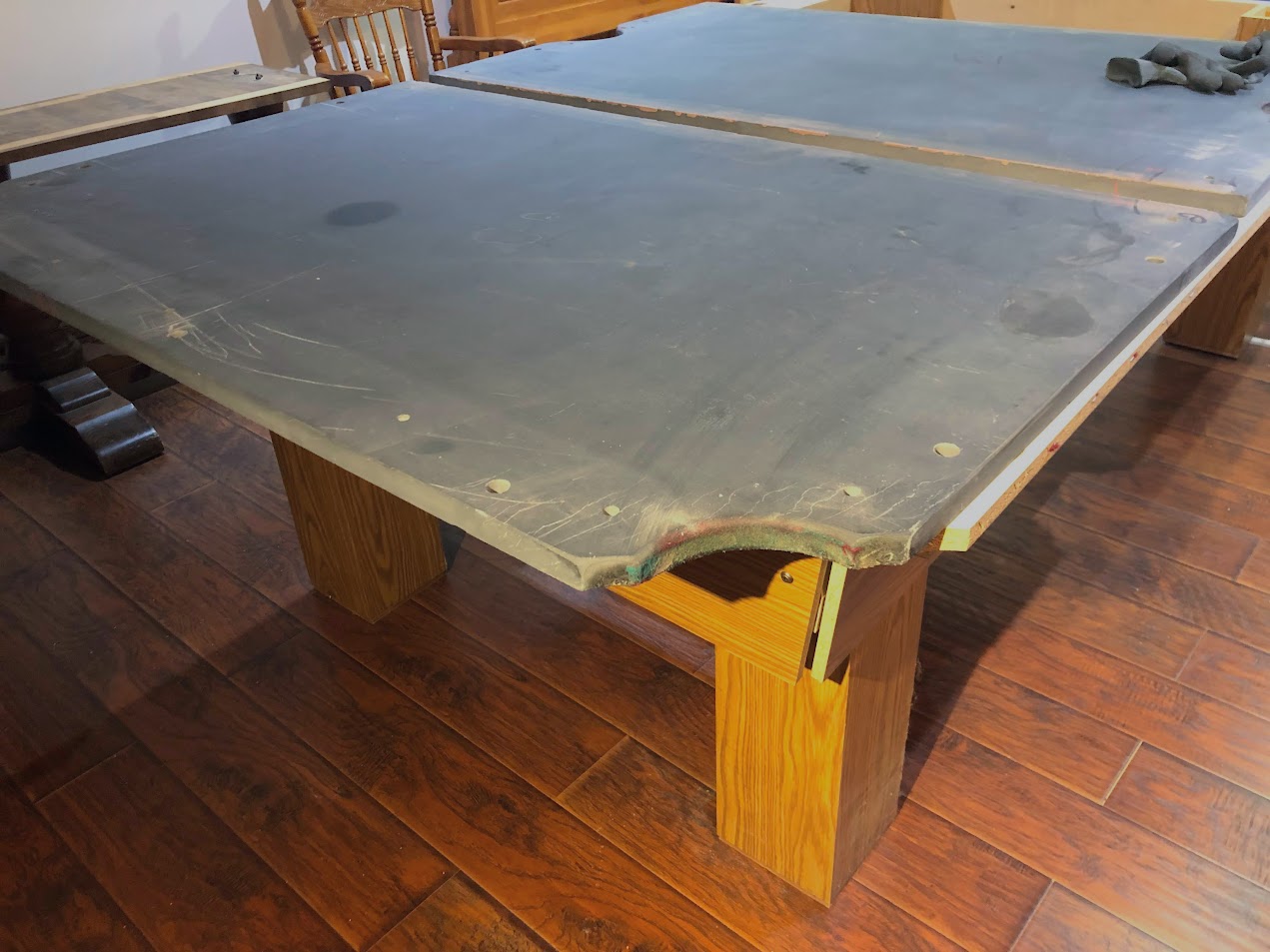 Slate playing surface covered with protective sheet during assembly