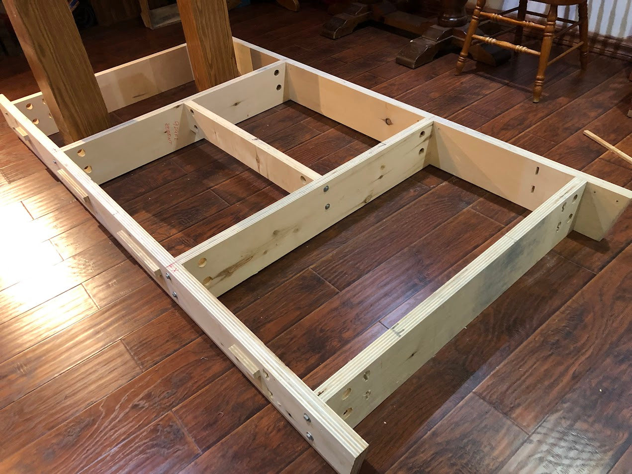 Wooden base frame components laid flat showing assembly layout