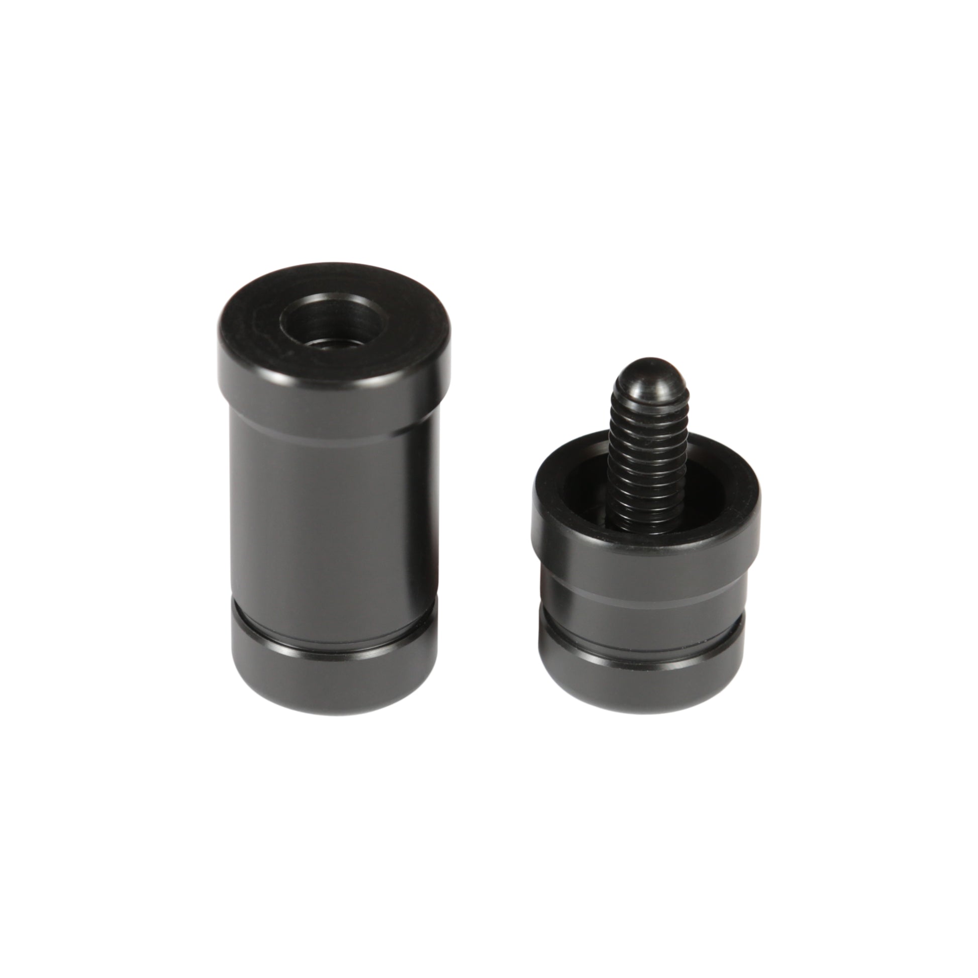Black billiard cue joint protectors displayed apart, showing internal threads.