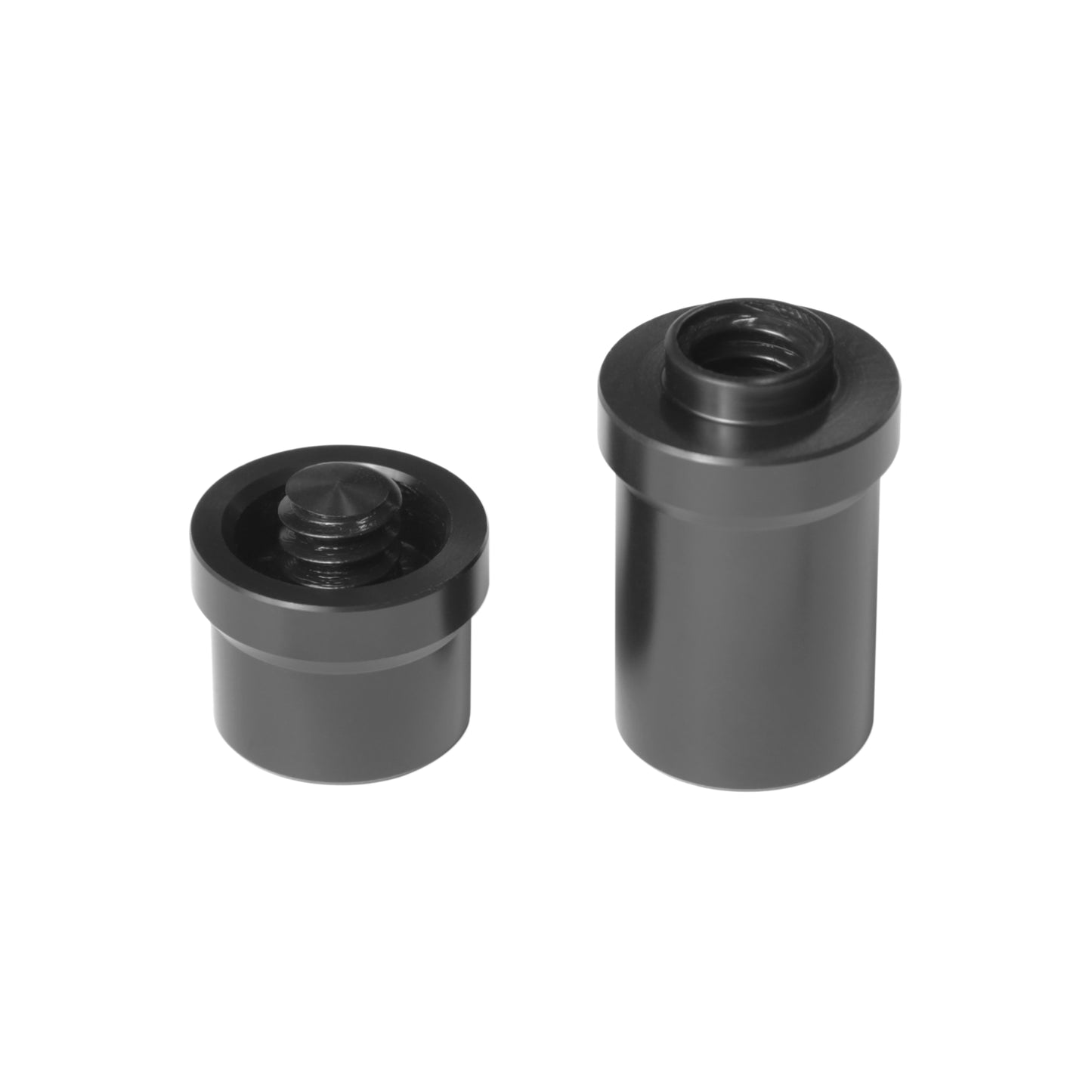 Black joint protectors, one showing internal threading for cues
