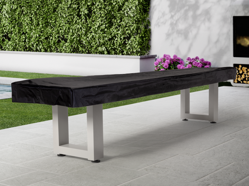 Shuffleboard table with black protective cover in patio setting