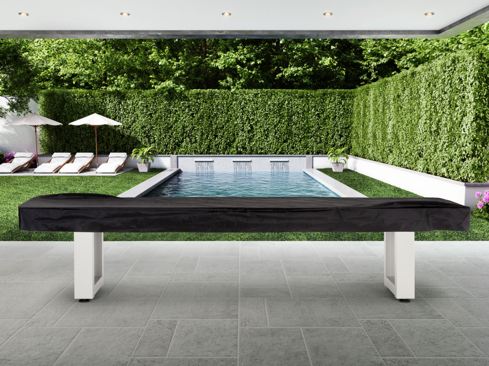 Covered shuffleboard table positioned in landscaped outdoor area