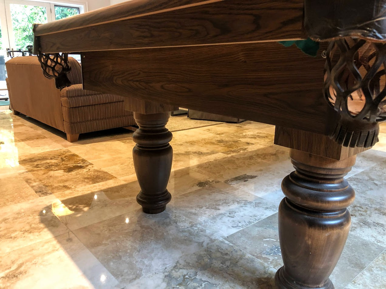 Low angle shot of table legs and carved pocket showing wood grain and finish