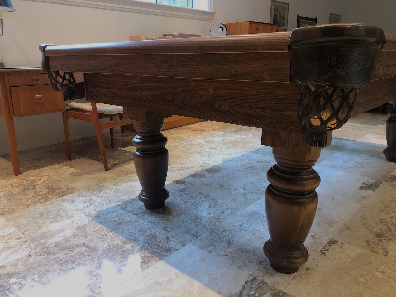 Side profile of turned wooden leg with decorative detailing and leather pocket