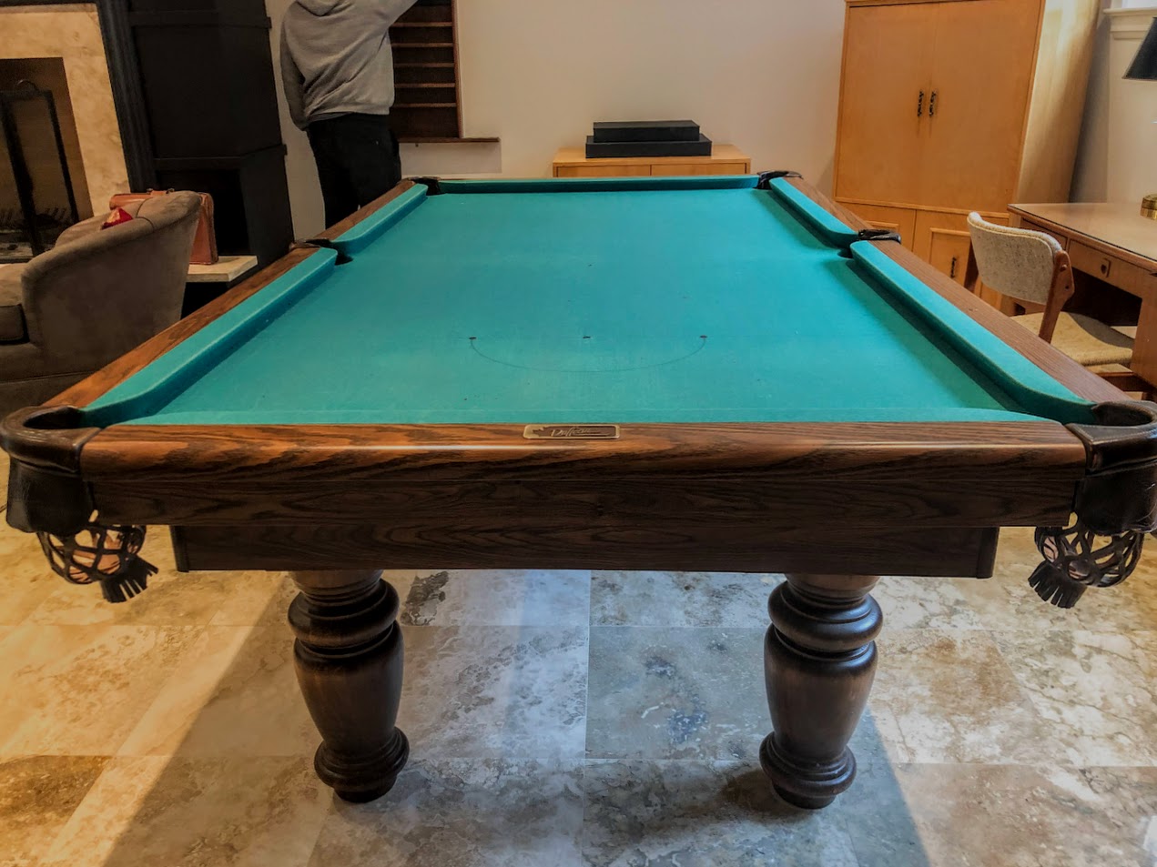Angled overhead perspective of table showing turquoise felt and dark wood frame