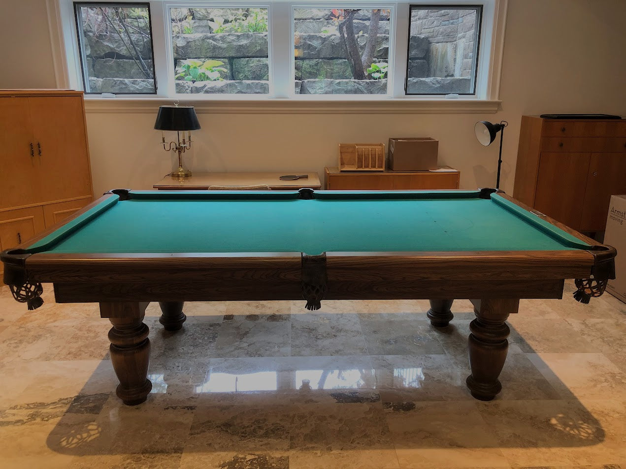Front view of snooker table with turquoise playing surface in game room