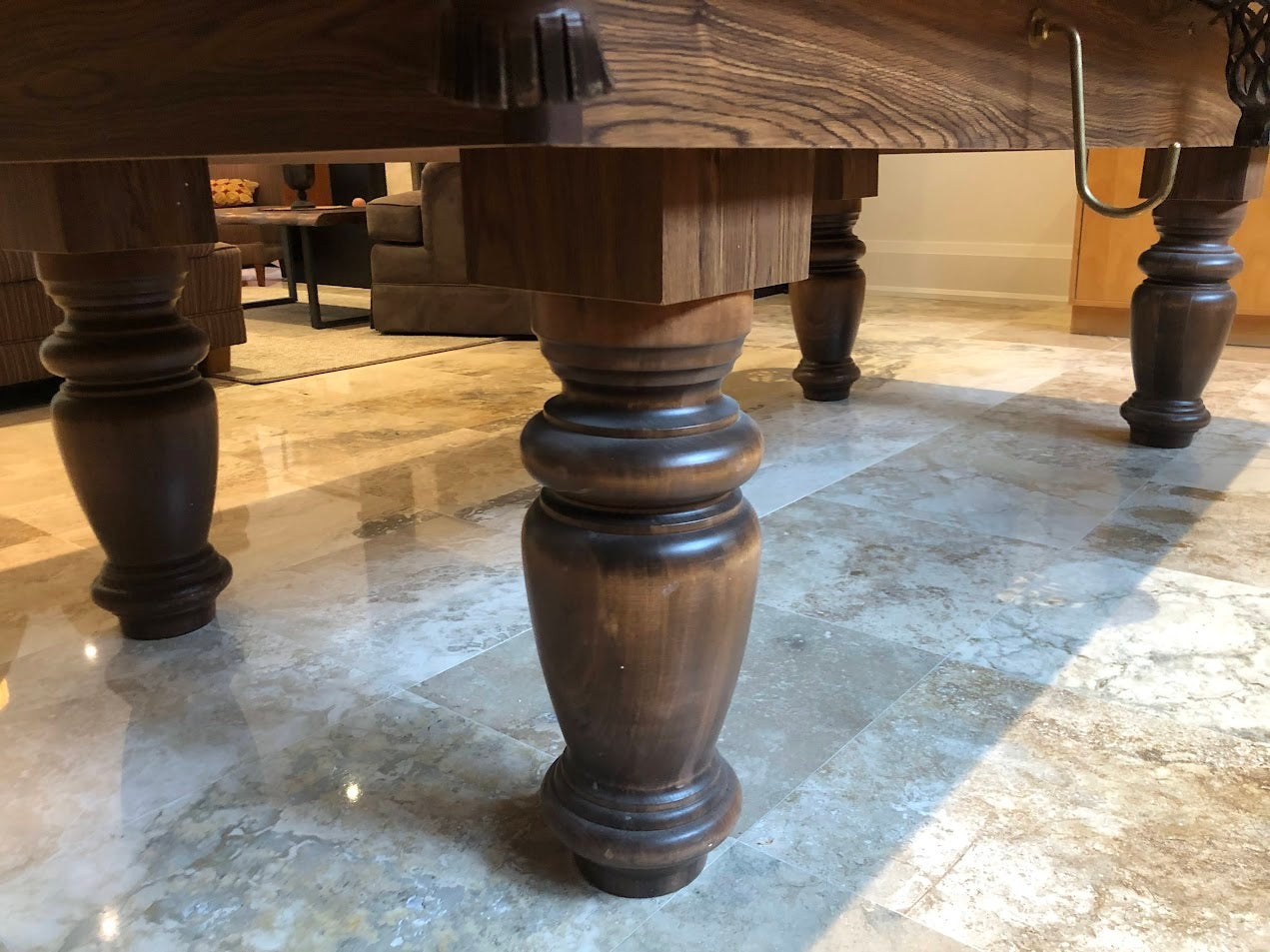 Underneath view of table revealing support structure and turned leg construction