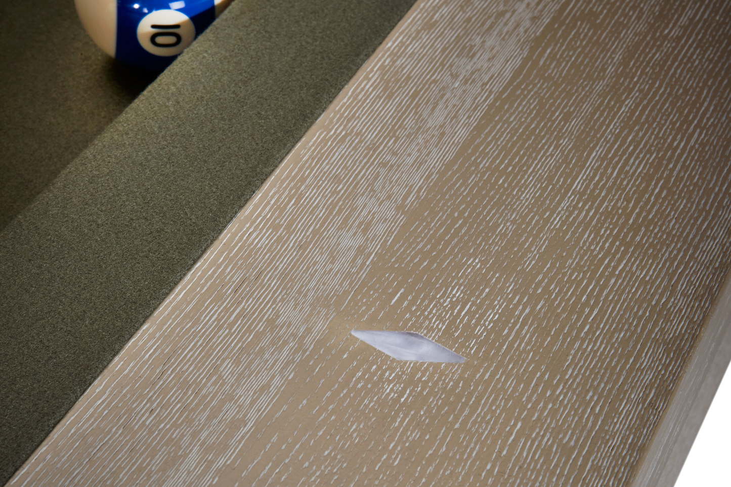 Close-up detail of wood grain texture on natural ash rail trim and cloth surface
